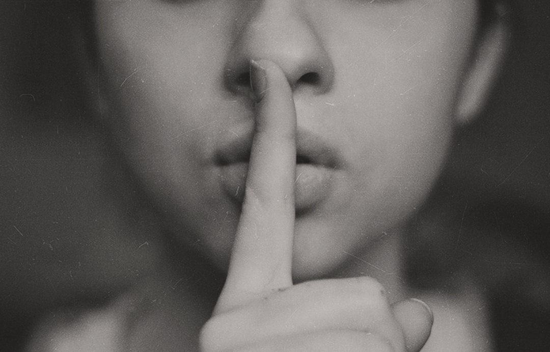 Photo by Kristina Flour grayscale photo of woman doing silent hand sign